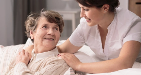 Nurse comforting elderly woman